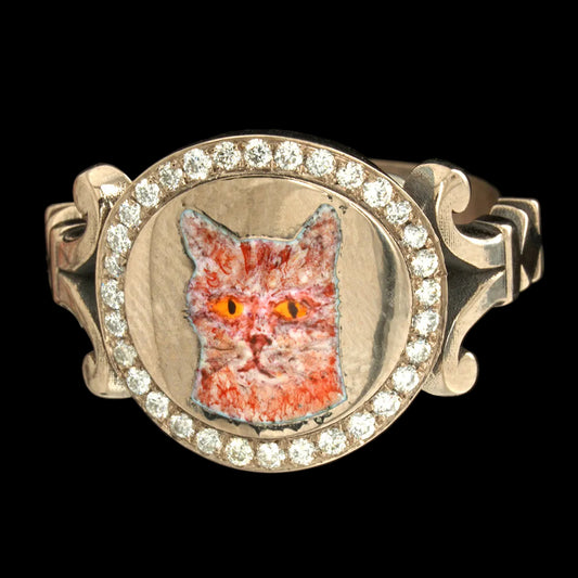 White gold ring with a cat face in enamel and a diamond halo on a black background background