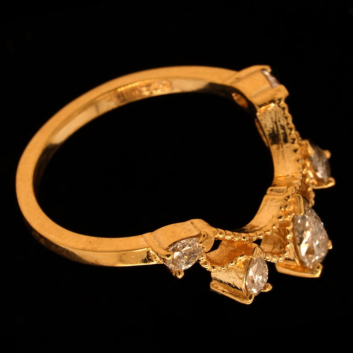 A handcrafted 9ct yellow gold engagement ring featuring graduated salt and pepper pear shaped diamonds set in a tiara-inspired design.
