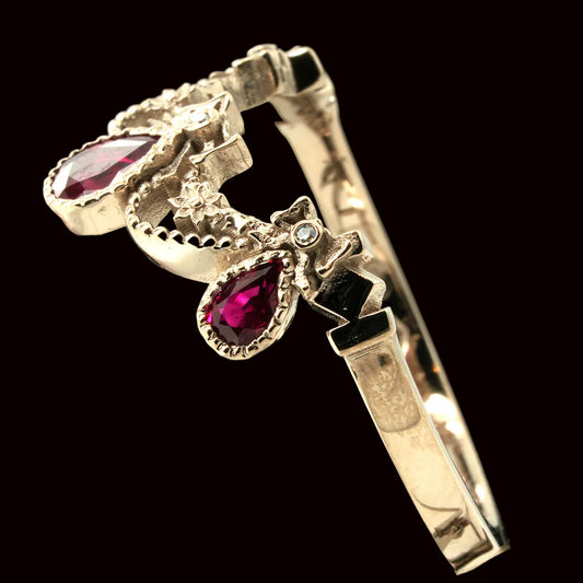 Gold ring with rubies on a black background