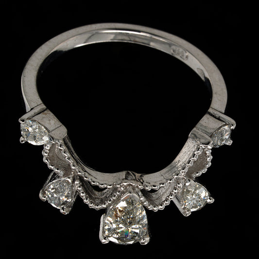 White gold tiara inspired ring with five pear shaped diamonds on a black background