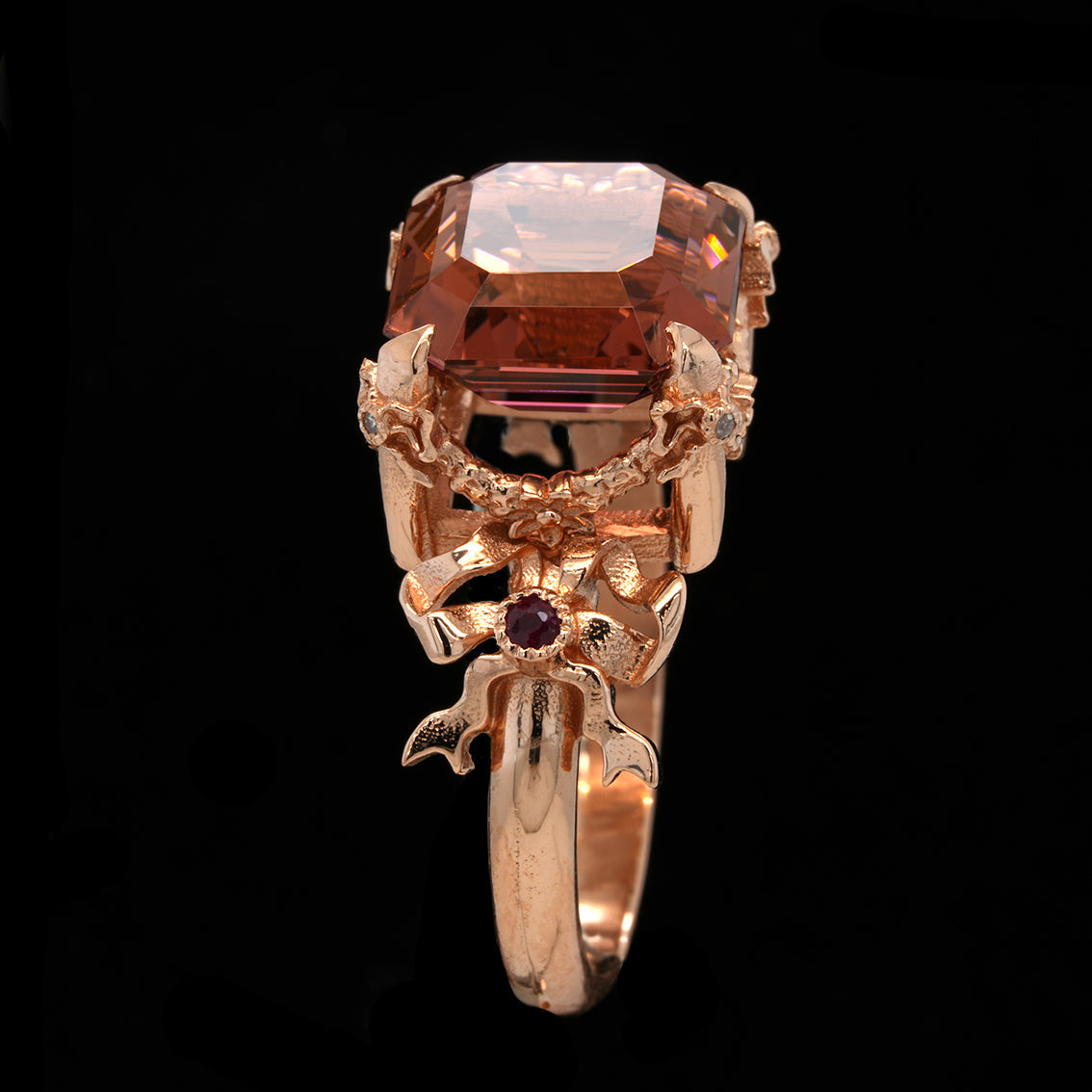Gold ring with a large square tourmaline gemstone on a black background