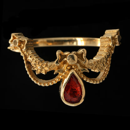 BERIBBONED ORANGE SAPPHIRE RING