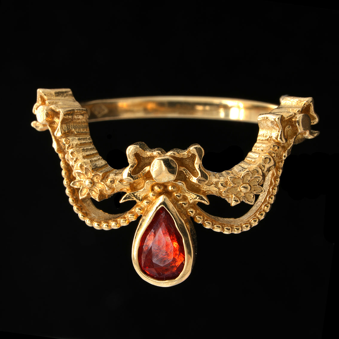 BERIBBONED ORANGE SAPPHIRE RING