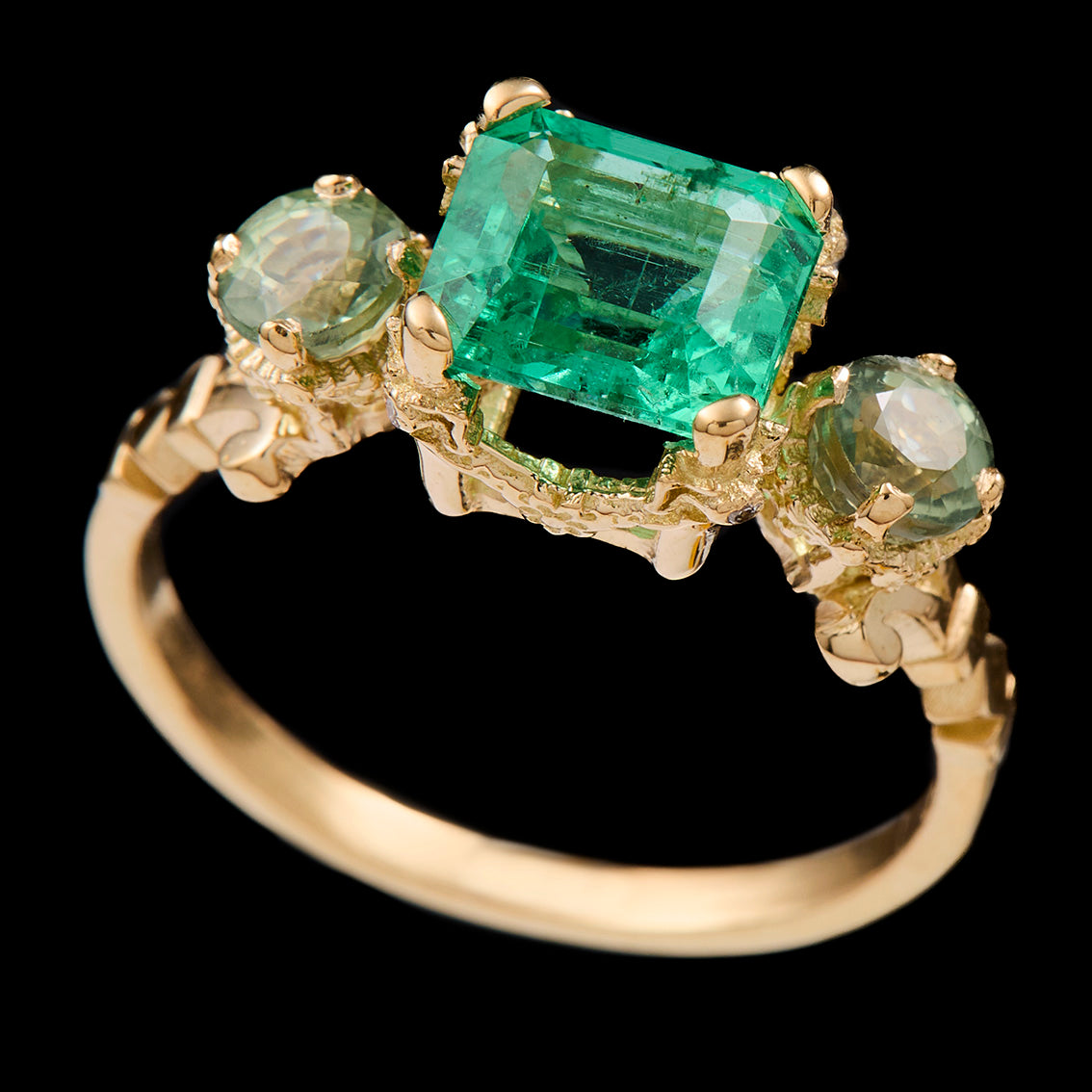 Gold ring with an emerald and sapphires
