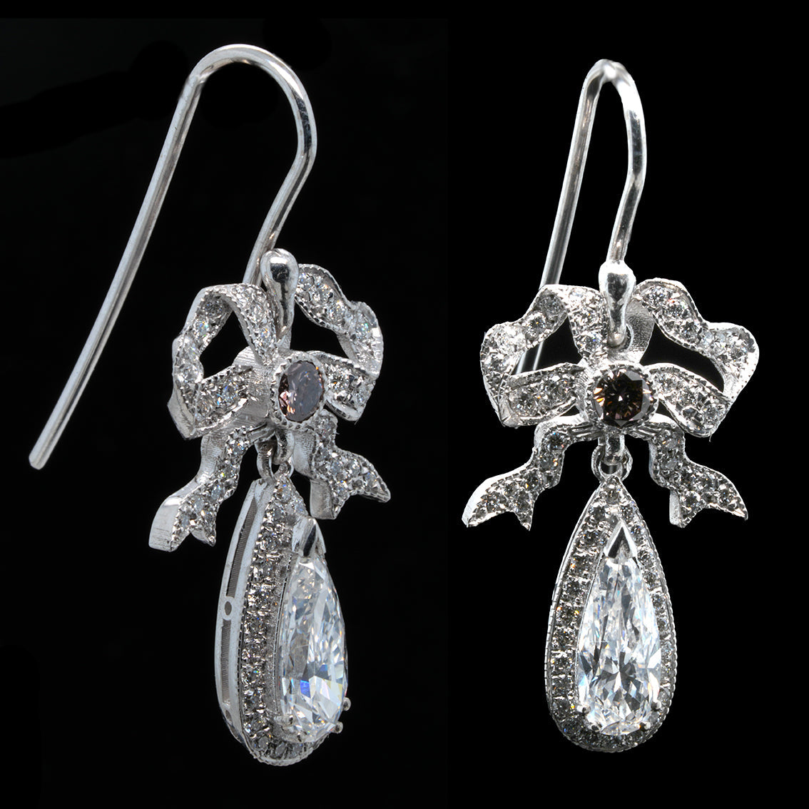 Pair of diamond earrings with bow design on a black background