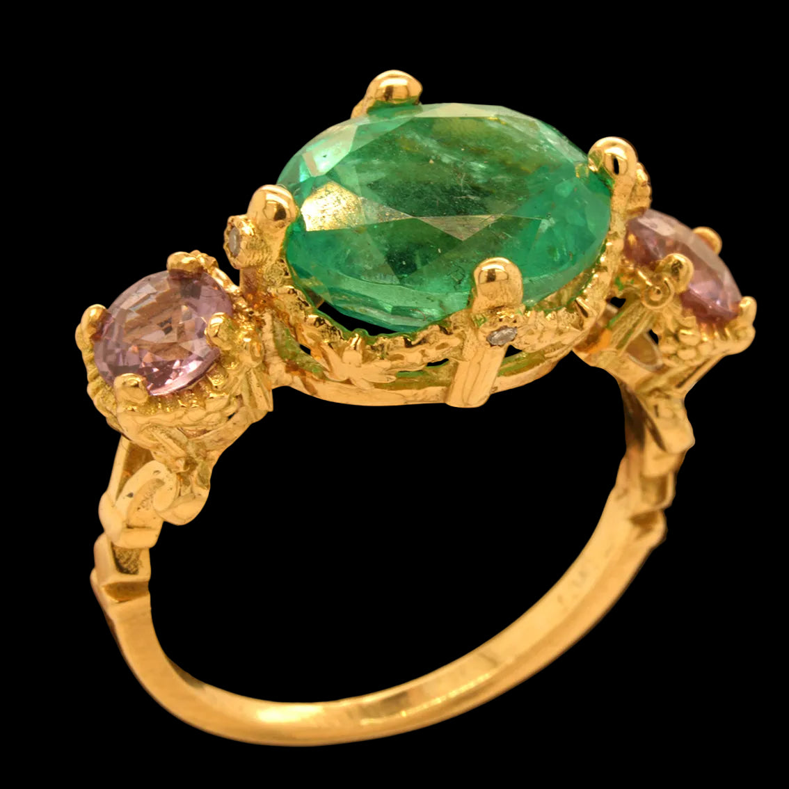 Gold ring with a green gemstone and purple stones on a black background