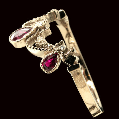 Gold ring with rubies on a black background