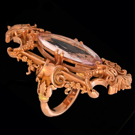 Very detailed rose gold ring with baraque infuences on black background